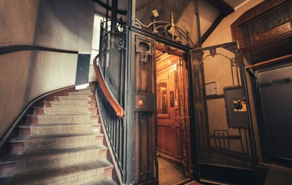 a staircase with a wrought iron door and railing